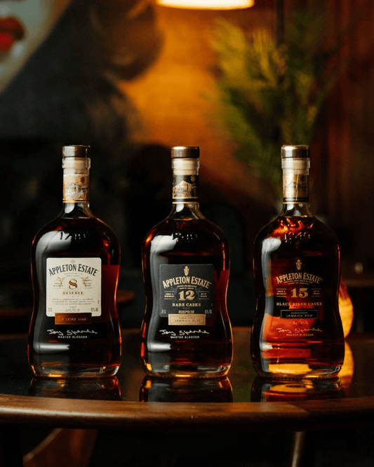 Assortment of Jamaican rum bottles on a tropical background – history and culture of Jamaican rum